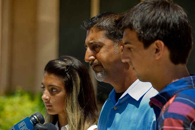 Misty Holt-Singh was fatally injured during the shootout between Stockton police officers and bank robbers on Wednesday, July 16, 2014. Her daughter, Mia Singh, left, husband, Paul Sr. Singh, center and son Paul Singh Jr. speak at a news conference held by the Holt-Singh family on Friday, July 18, 2014 in Stockton, Calif. 