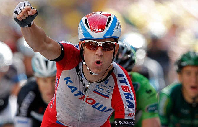 Norway's Alexander Kristoff crosses the finish line to win the fifteenth stage of the Tour de France cycling race over 222 kilometers (137.9 miles) with start in Tallard and finish in Nimes, France, Sunday, July 20, 2014. 
