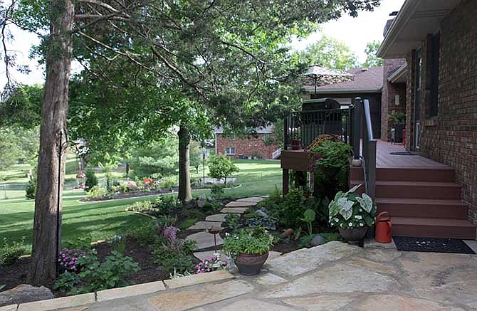 The yard of the month for July was manicured by Don and Merrilee Holzhauser. The couple have only been in the house for two years, but have been able to cultivate an extensive garden in the short time. "What we love
about it is it's like we are in the country," Merrilee said about her garden.