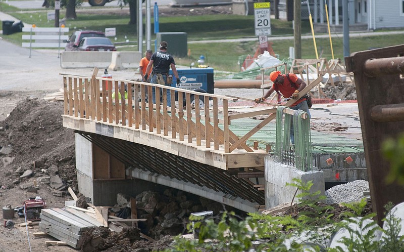 Workers make progress on the Seventh Street Bridge Tuesday afternoon. City Engineer Greg Hayes reported to the Fulton City Council at its meeting Tuesday that utility conduit was recently placed and concrete sidewalk and approach slabs will be poured next week.