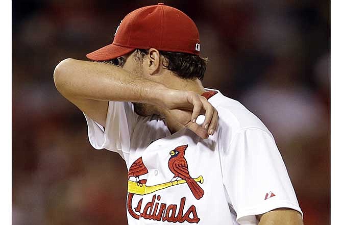 St. Louis Cardinals starting pitcher Adam Wainwright pauses on the mound after giving up a ground-rule double to Tampa Bay Rays' Yunel Escobar scoring two runs during the fifth inning of a baseball game Tuesday, July 22, 2014, in St. Louis.