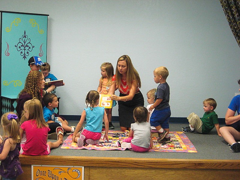 Tawnya Claus and Emily Ziehmer working with the children during story time in the new addition at Wood Place Public Library.
