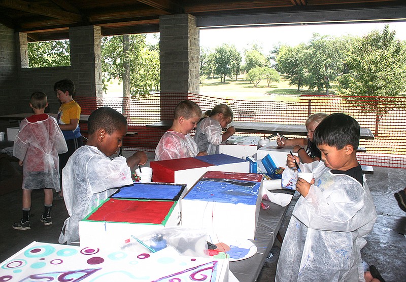 Participants of the "Explore the World" art class hosted by the City of California Parks and Recreation Department create passports Monday afternoon at Proctor Park. 
