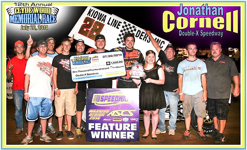 Clyde Wood's granddaughter Felicia Braun presents the trophy for the feature win in the Winged Sprint division to Jonathan Cornell, Sedalia, following his victory at the Clyde Wood Memorial Races Sunday, July 20, at the Double-X Speedway, California. Taking part in the celebration at far right is Clyde's son Roy Wood, who serves as Double-X Speedway and ASCS Director of Competition. 
