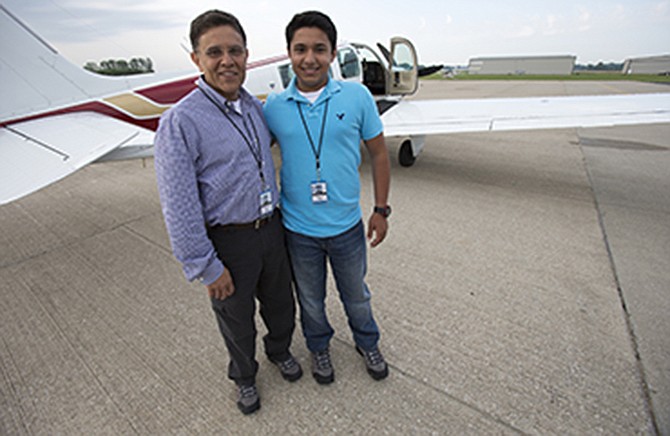 Babar Suleman and son Haris Suleman, 17, stand next to their plane at an airport in Greenwood, Indiana before taking off for an around-the-world flight on June 19. On Wednesday, a single-engine plane with two aboard crashed in waters off American Samoa, with a registration number matching the plane flown by the Indiana teen.