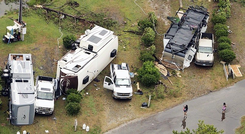 People inspect damage at Cherrystone Family Camping & RV Resort in Northampton County, Virginia, Thursday after a severe storm swept through the area.