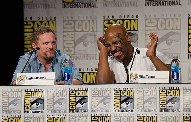 Hugh Davidson, left, and Mike Tyson attend the "Mike Tyson Mysteries" panel on Day 2 of Comic-Con International on Friday, July 25, 2014, in San Diego.