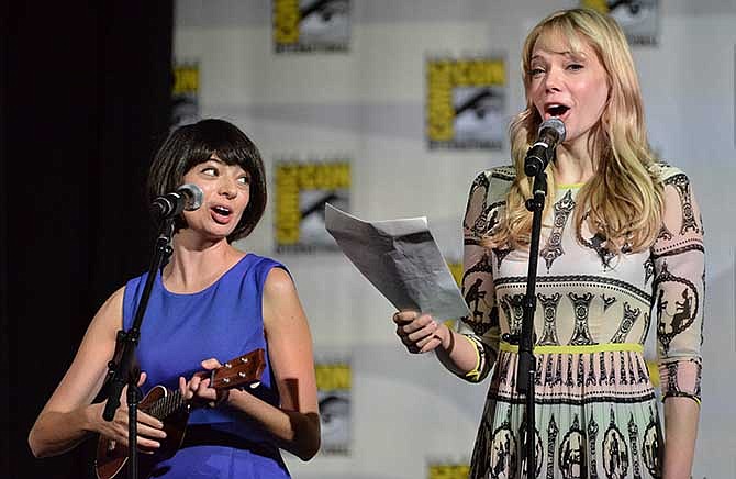 Kate Micucci, left, and Riki Lindhome perform on stage during the "The Big Bang Theory" panel on Day 2 of the Comic-Con International Convention on Friday, July 25, 2014, in San Diego.