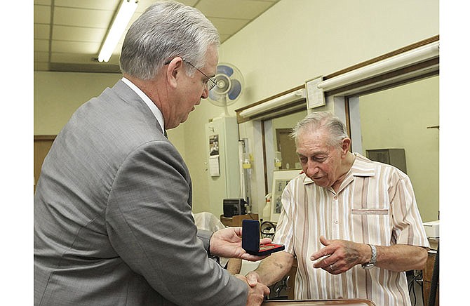 Gov. Jay Nixon has proclaimed Sunday, July 27, Korean War Veterans Day in Missouri and visited Larry Horstdaniel at Larry's Barber Shop in downtown Jefferson City to present the 86-year-old vet with an official resolution and the medal.