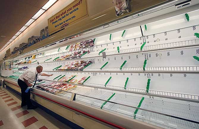 Meat manager Dave Fillebrown wipes down largely empty shelves Thursday, July 24, 2014 at a Market Basket supermarket in Haverhill, Mass. A decades-long family feud, which brought about the ouster of Arthur T. Demoulas as CEO of the privately held company, led to a worker revolt, customer boycotts and empty shelves in the grocery chain's stores in Maine, Massachusetts and New Hampshire. More than 100 Massachusetts legislators and mayors, Massachusetts Attorney General Martha Coakley, and New Hampshire Gov. Maggie Hassan have publicly supported the employees.