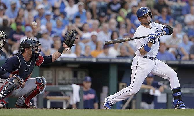 Cleveland Indians catcher Yan Gomes misses a pitch with Kansas City Royals' Omar Infante (14) at bat to allow Norichika Aoki to score during the fourth inning of a baseball game against the Cleveland Indians Saturday, July 26, 2014, in Kansas City, Mo. 