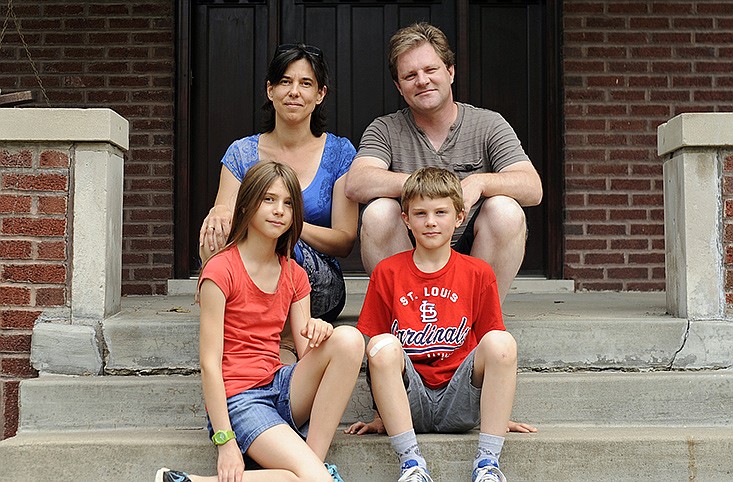 French vacationers Valerie, left, and Sylvain Tronche sit with their children Noemie (11) and Raphael (9) on the front stoop of the Elmerine Avenue home where they have been staying for part of the summer. The Tronches, residents of the Amiens suburb of Plachy-Buyon, exchanged homes with Jefferson City residents Patrick and Becky Lynn and their two children, who in turn vacationed in the Tronches' home in northern France.