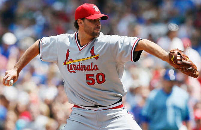 St. Louis Cardinals starting pitcher Adam Wainwright delivers against the Chicago Cubs during the first inning of a baseball game on Sunday, July 27, 2014, in Chicago. 