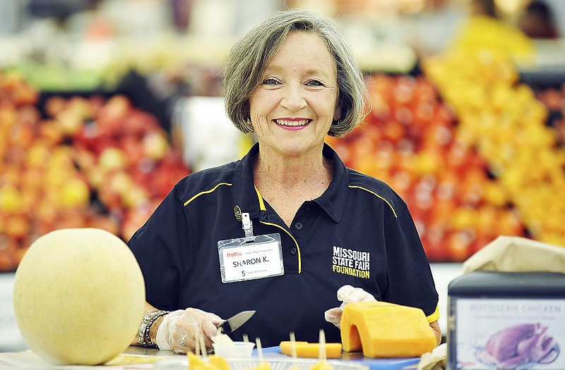 Sharon Kirchoff serves locally grown cantaloupe at HyVee.