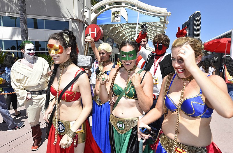 Costumed characters walk outside of the convention center on day 1 of the 2014 Comic-Con International Convention held Thursday in San Diego.