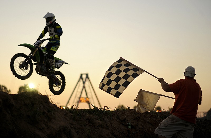Brandon Goring sails over the finish line in the 250 B class event during Monday's motocross at the Jefferson City Jaycees Cole County Fair.