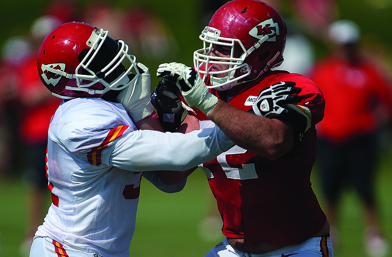 Chiefs linebacker Tamba Hali (left) is blocked by tackle Eric Fisher during a drill Monday at training camp on the Missouri Western State University campus in St. Joseph, Mo.