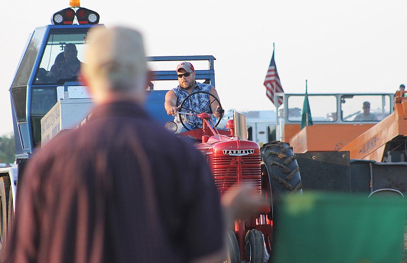 Shawn Smart of Tebbetts participates in the tractor pull Wednesday at the Kingdom of Callaway County Fair. Smart competes with a tractor dedicated to his great uncle, Wilson Smart.