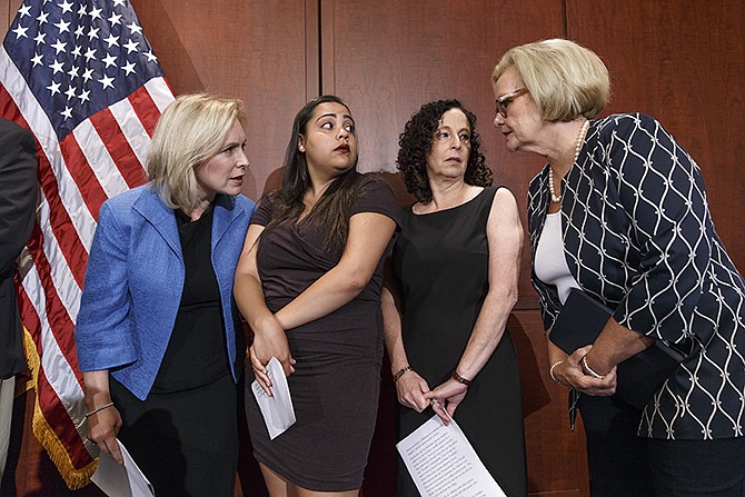 From left, Sen. Kirsten Gillibrand, D-N.Y., Anna, a survivor of sexual assault, with her mother Susan, and Sen. Claire McCaskill, D-Mo., talk to each other during a news conference on Capitol Hill in Washington, Wednesday, to discuss "Campus Accountability and Safety Act" that is before the Senate. 