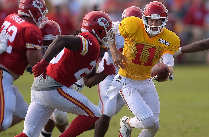 Chiefs quarterback Alex Smith hands the ball off to Jamaal Charles during training camp Wednesday in St. Joseph.