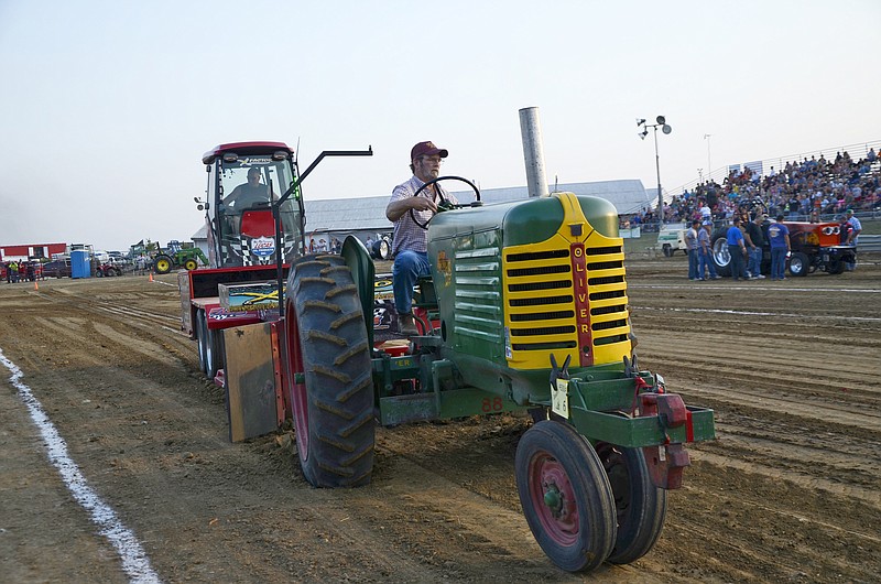 John Lepper drives his tractor during a tractor pull at the Jefferson City Jaycees Cole County Fair on Thursday. Lepper said he competes in 12 to 15 tractor pulls each year. "I grew up on a farm. It's something I can do, bring back old memories," he said. "And it's competitive."