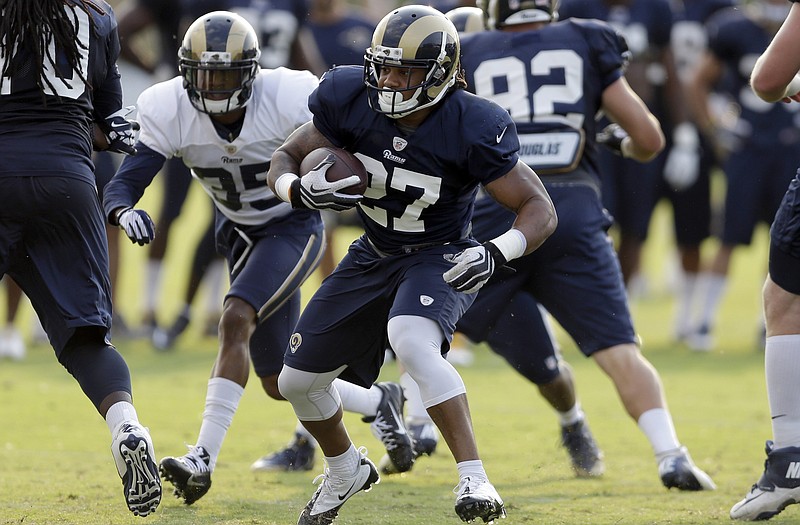 Rams running back Tre Mason goes downfield with the ball Thursday during a session of training camp in St. Louis.