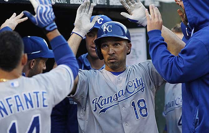 Kansas City Royals' Raul Ibanez is greeted in the dugout after hitting a home run against the Oakland Athletics during the fifth inning of a baseball game, Friday, Aug. 1, 2014, in Oakland, Calif.