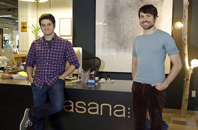 Asana co-founders Dustin Moskovitz, left, and Justin Rosenstein, pose at the company's headquarters in San Francisco. Asana peddles software that combines the elements of a communal notebook, social network, instant messaging application and online calendar to enable teams of employees to share information and do most of their jobs without relying on email.