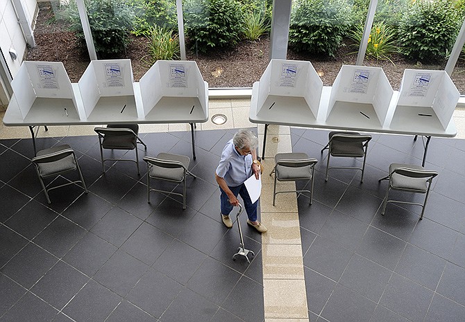 Ward 2, Precinct 1 voter Gilberte Brashear walks away from the Miller Performing Arts Center polling station after filling out her ballot during Tuesday's primary elections.