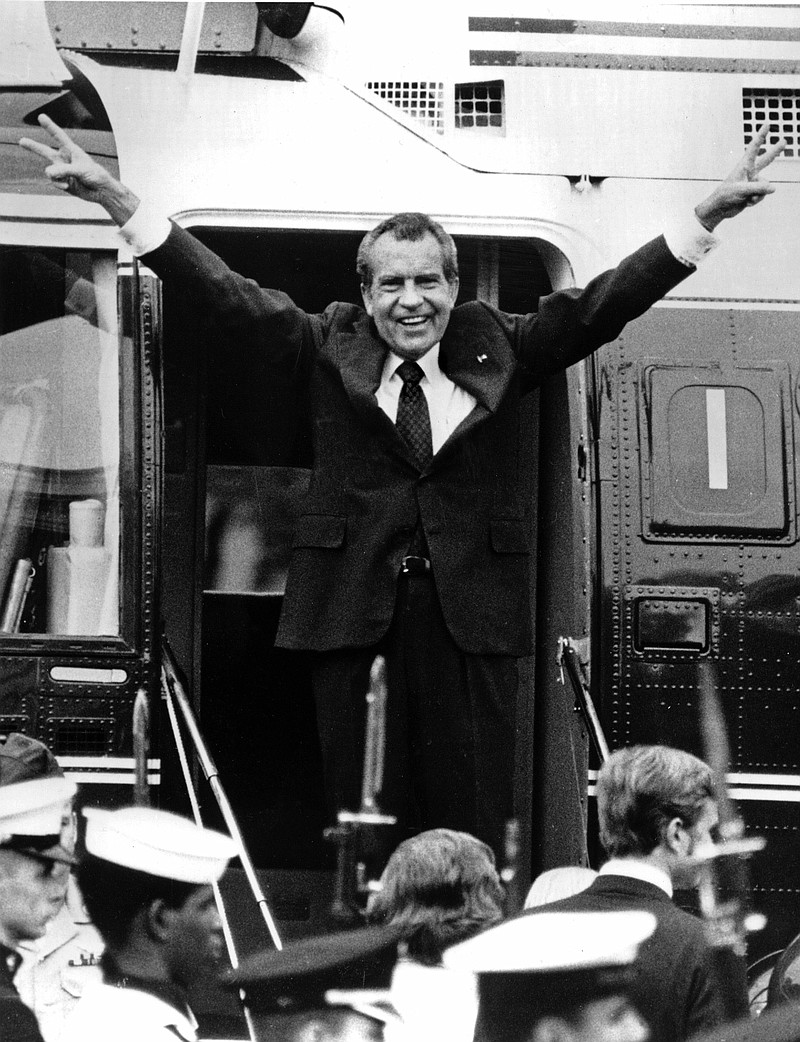 Richard Nixon waves goodbye with a salute to his staff members outside the White House as he boards a helicopter and resigns the presidency on Aug. 9, 1974. He was the first president in American history to resign the nation's highest office. 
