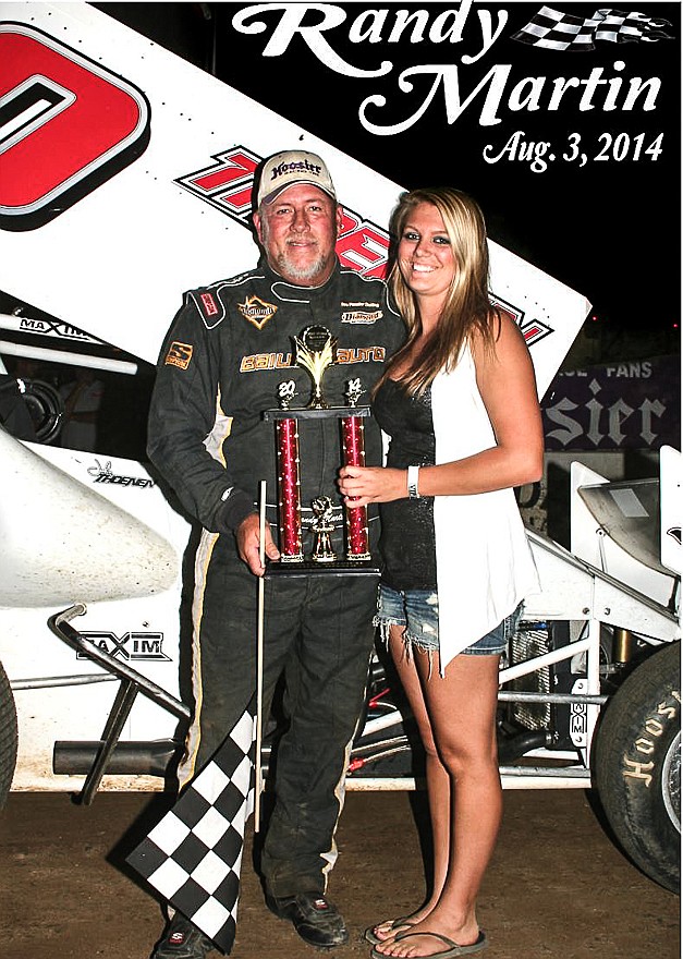California's own Randy Martin is presented his trophy from Kelsey Brauner, California, after winning the 25th consecutive season finale main event in the 360 Winged Sprint division Sunday night at the Double-X Speedway, California.
