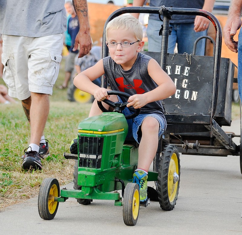 Caleb Howard pulled to first place Monday night in the lightest weight division at the Moniteau County Fair Kiddie Tractor Pull.