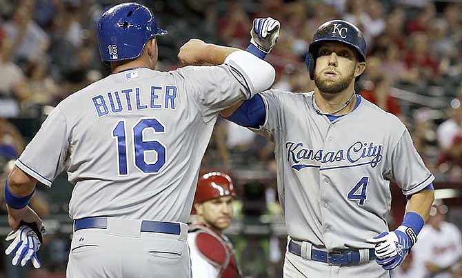 Kansas City Royals' Alex Gordon (4) celebrates his two-run home run against the Arizona Diamondbacks with Billy Butler (16) during the second inning of a baseball game Thursday, Aug. 7, 2014, in Phoenix.