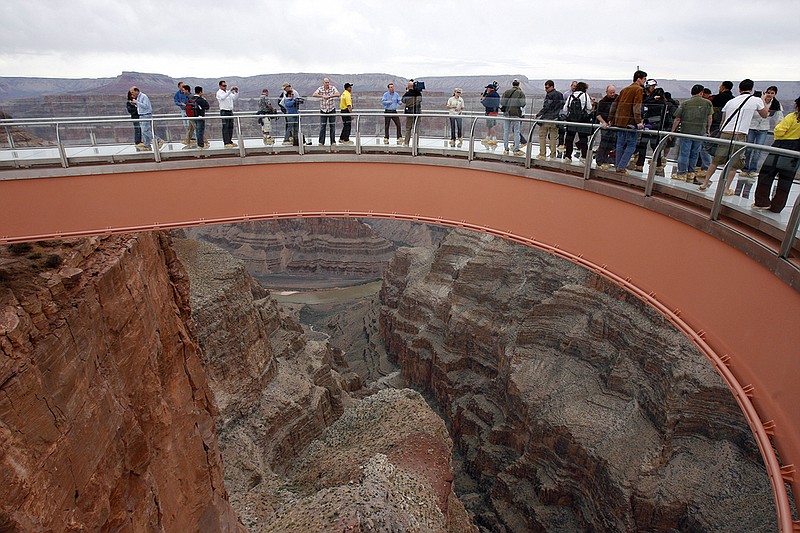 People walk on the Grand Canyon Skywalk on the Hualapai Indian Reservation in northwestern Arizona. A ceremony is planned Tuesday to mark completion of a newly-paved road which leads to the Skywalk.