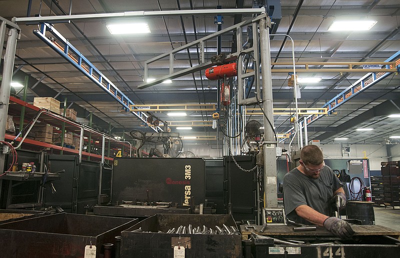 A Danuser Machine Company employee works inside the company's new addition Friday. The latest facility has given the company 32,000 more square feet, increasing its total square footage to more than 100,000. Demand of its attachments caused the company to build a bigger space.
