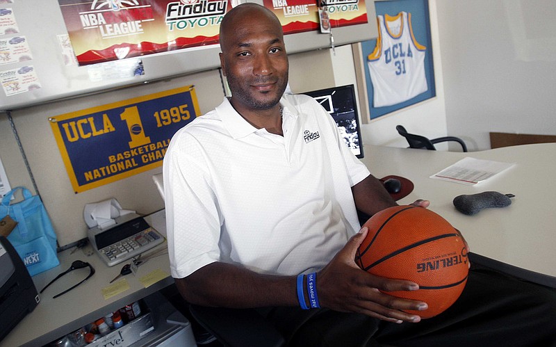 In this Sept. 18, 2010, file photo, former UCLA basketball player Ed O'Bannon Jr. sits in his office in Henderson, Nev. A federal judge ruled Friday, Aug. 8, 2014 that the NCAA can't stop college football and basketball players from selling the rights to their names and likenesses, opening the way to athletes getting payouts once their college careers are over.