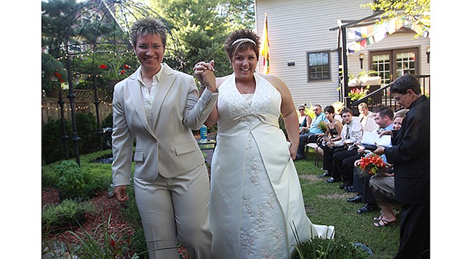 Lisa Layton-Brinker and her partner JoDe walk back up the aisle following their wedding in Iowa. The couple is one of eight couples suing the state of Missouri to recognize same-sex marriages that took place in states where it's legal.