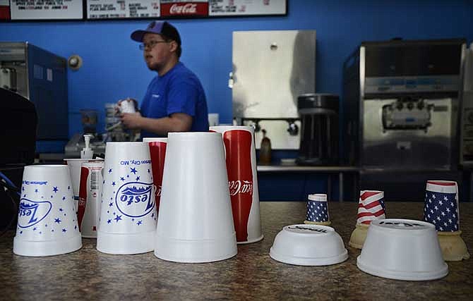 Nick Wills, a manager at Zesto Drive-In on Broadway St. in Jefferson City serves ice cream to customers on Friday, Aug. 8, 2014. The restaurant will close and move to a new location on High Street this fall. "I kind of have some mixed feelings about it," Wills said, noting he feels nostalgic for the Broadway location, where he started working in 2008.