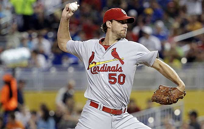 St. Louis Cardinals starting pitcher Adam Wainwright throws in the first inning during a baseball game against the Miami Marlins, Tuesday, Aug. 12, 2014, in Miami.