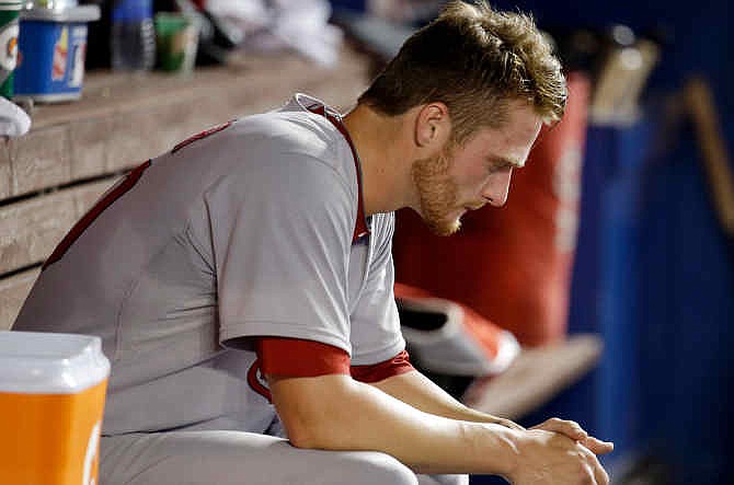 St. Louis Cardinals starting pitcher Shelby Miller sits in the dugout after pitching in the fourth inning during a baseball game against the Miami Marlins, Monday, Aug. 11, 2014, in Miami.