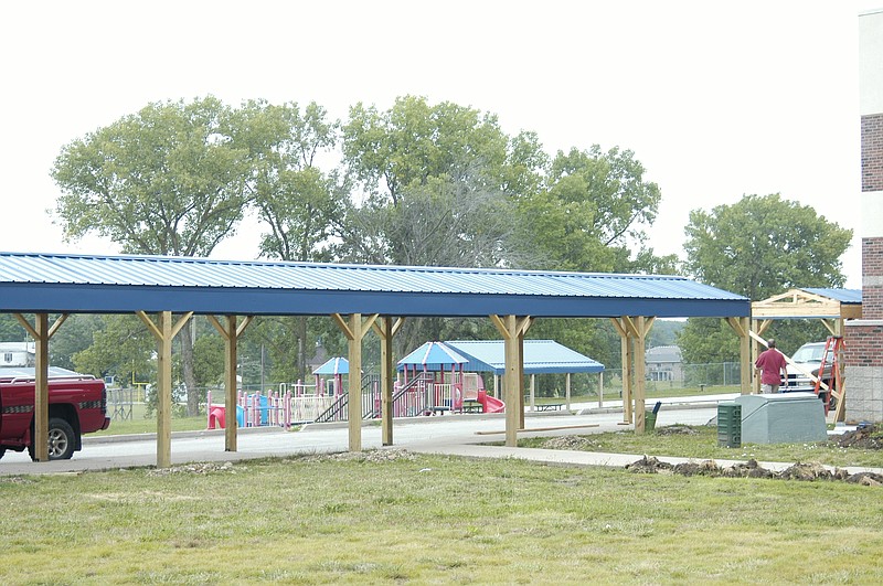 The new walkway covers at the middle and elementary school bus pickup and dropoff will help in rainy and snowy weather.