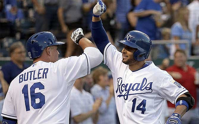 Kansas City Royals' Omar Infante celebrates with Billy Butler after Infante hit a two-run home run during the third inning of a baseball game against the Oakland Athletics Wednesday, Aug. 13, 2014, in Kansas City, Mo.