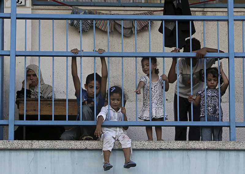 Displaced Palestinian children play on the balcony of the U.N. school where their family sought refuge during the war, in Beit Lahiya, in the northern Gaza Strip, Tuesday. Tens of thousands of Palestinians have been displaced in the Israel-Hamas war.