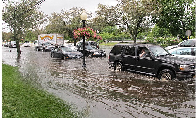 Vehicles attempt to maneuver down a flooded Montauk Highway in Babylon, New York, Wednesday. The National Weather Service says parts of Long Island experienced record-setting rainfall in the past 24 hours. In one community, more than 13 inches of rain was reported.