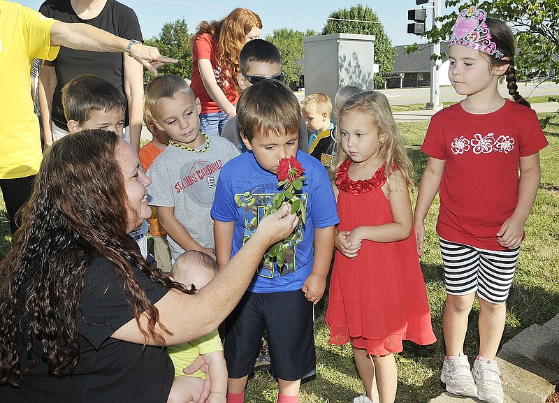 Sometimes you just have to stop and smell the roses, even on the first day of school. Wednesday was the first day back to school at The Special Learning Center and students were excitedly checking out the new items around the campus. Tate Wahlquist sniffs the rose while April Drewel holds it and classmates Tyler Sandbothe, second from left, Addison Mutert, second from right, and Madeline Eiken wait their turn.