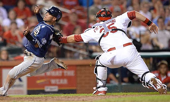 St. Louis Cardinals' A.J. Pierzynski (35) tags out San Diego Padres' Alexi Amarista at the plate in the ninth inning in a baseball game, Thursday, August 14, 2014, at Busch Stadium in St. Louis. 