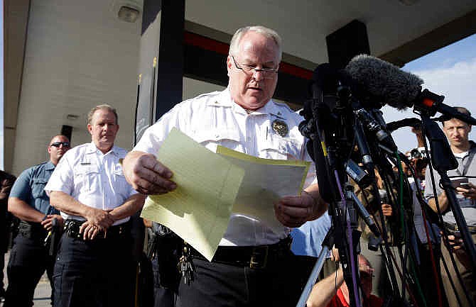 Ferguson Police Chief Thomas Jackson releases the name of the the officer accused of fatally shooting Michael Brown, an unarmed black teenager, Friday, Aug. 15, 2014, in Ferguson, Mo. Jackson announced that the officer's name is Darren Wilson.