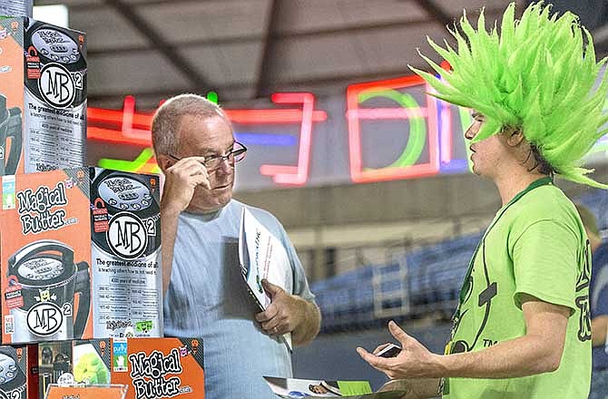 Dale Rennaker of Vancouver talks with Chris Whitener, a Magic Butter company service representative about the MB2 magical butter machine during the first "Cannacon" convention Thursday, Aug. 14, 2014, at the Tacoma Dome in Tacoma, Wash. 