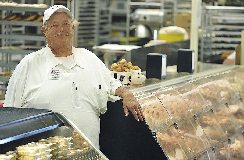 Schulte's baker Dave Siebeneck stands behind the doughnut case. Many people agree Schulte's makes the best doughnuts in the area.