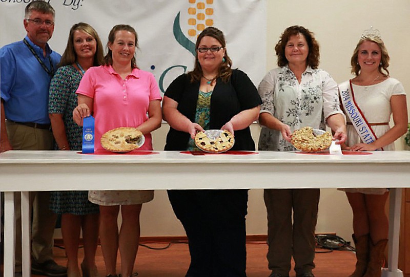 Erin Rinehart, of Fulton, received second place in the Fruit Pie division with her blue berry & raspberry pie at the First Lady's Pie Contest in Sedalia at the 2014 Missouri State Fair on Aug. 14. Pictured left to right are: Director of Agriculture Richard Fordyce, Renee Fordyce, Katherine Kanneman, Erin Rinehart, Laura McDougald, and 2014 Missouri State Fair Queen Hanna Keene.
